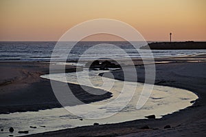 Mouth of the Ancora river in the atlantic ocean at sunset. Beach of Vila Praia de Ancora. Municpality of Caminha, Portugal.