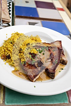 Andalusian cuisine, spicy cous-cous with grilled pork ham filet