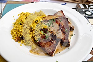 Andalusian cuisine, spicy cous-cous with grilled pork ham filet