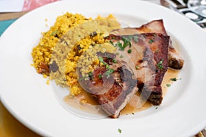 Andalusian cuisine, spicy cous-cous with grilled pork ham filet