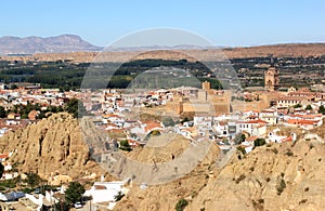 Andalusian town Guadix between mountains in Spain