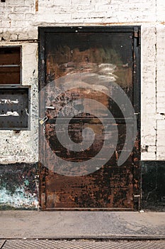 Anderlecht, Brussels Capital Region, Belgium - Worn rusty metal door in a cellar