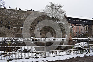 Andernach, Germany - 01 17 2021: City walls with a pond within the modern town during winter