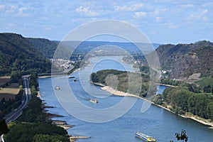Andernach, Germany - 08 27 2020: Rhine with heavy ship traffic at riverbanks and island