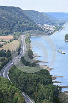 Andernach, Germany - 08 27 2020: Rhine with ship and main road B9 with little traffic