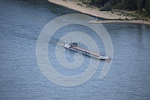 Andernach, Germany - 08 27 2020: single cargo ship in the blue Rhine