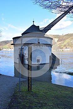 Andernach, Germany - 02 04 2021: Flood scale and Roman crane ' Alter Kahnen ' in the Rhine flood