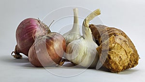 Andfresh garlic,ginger and onion on a white isolated surface