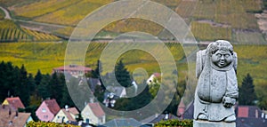 Andlau, Alsace village, vineyard, statue of monk carrying wine barrel