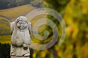 Andlau, Alsace village, vineyard, statue of monk carrying wine barrel