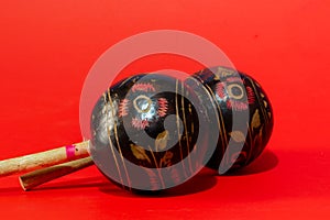 Andmade maracas isolated on red background