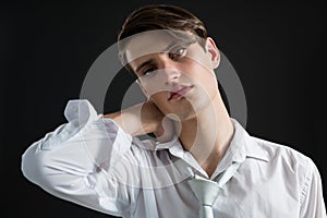 Androgynous man posing with hands on his head