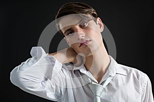 Androgynous man posing with hands on his head photo