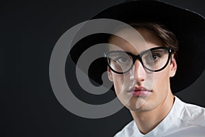 Androgynous man in spectacles