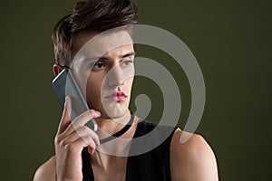 Androgynous man talking on mobile phone