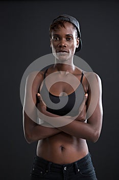 Androgynous person standing with his arms crossed