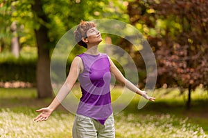 Androgynous woman enjoying fresh air in park