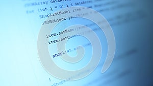 Android mobile development. Application source code on notebook blue screen background. Software developer programming code on co