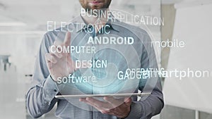 Android, smartphone, mobile, software, operating word cloud made as hologram used on tablet by bearded man, also used