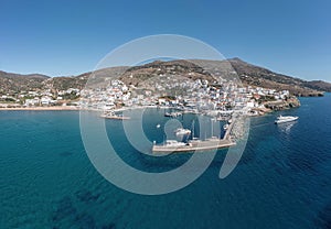 Andros island Batsi Cyclades Greece. Aerial drone view of port boat, building, sandy beach sea sky