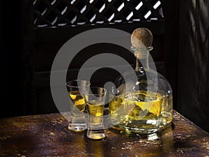 anejo and glasses on color background photo