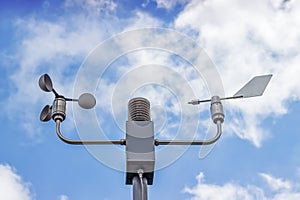 Anemometer and wind vane on blue sky