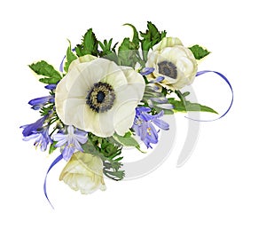 Anemones and blue agapanthus flowers in a corner floral arrangement isolated