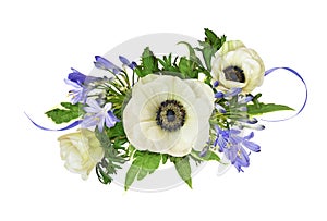 Anemones and blue agapanthus flowers in a floral arrangement isolated