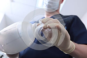 Anesthesiologist holds a spare set of medical equipment for breathing in his hand.Preparation for surgery under general