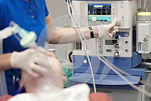 An anesthesiologist monitors the condition of a patient photo