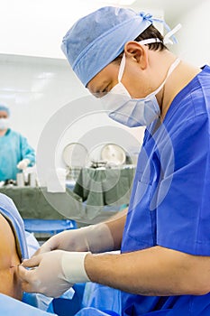 Anesthesiologist performing epidural anesthesia photo