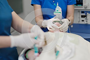 An anesthesiologists team enters the patient in general anesthesia