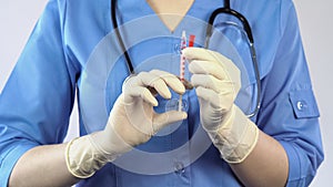 Anesthetist holding syringe in hands, diabetes insulin treatment, anesthesia