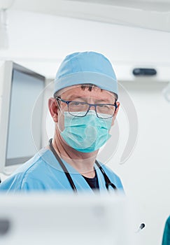 Anesthetist watching patient sleeping in operation room
