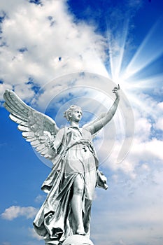 Angel archangel with divine rays of light and beautiful sky