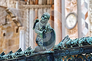 Angel with armor on the metal fence near the Cappella Colleoni was built with marble elements between 1472 and 1476 of the