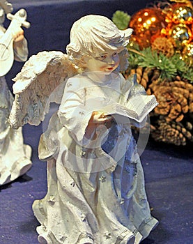 Angel on the background of Christmas tree branches