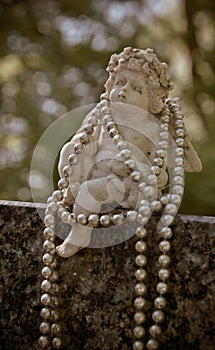 Angel with beads on a gravestone