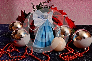 Angel from blue face protection mask burning candle and christmas decoration background
