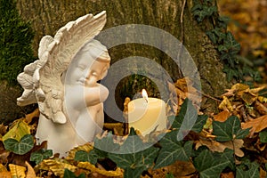 Angel with candle, nature cemetery photo