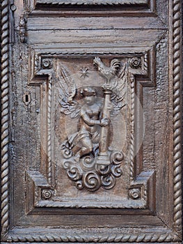 Angel carved on the wooden portal of an ancient Italian church