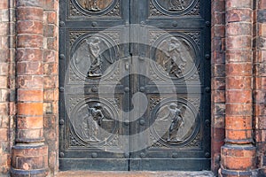 Angel carving on church doors in Berlin, Germany. Detail of the metallic panel on the temple doorway, entrance to the church.