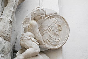 Angel, cherub and Christ Child is holding portrait of Jesus Christ
