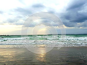 Angelic clouds and light on the water, photographed at Bloubergstrand, South Africa photo