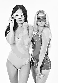 Angel and demon in masks, women play role game anonymously. Sinfulness and purity concept. girls in bodysuits looks
