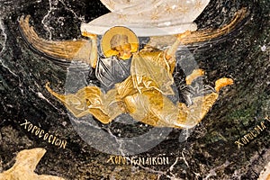 Angel flying in the black sky, an old byzantine wall-painting