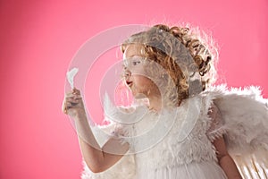 Angel girl holding a feather