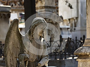 Angel without hands praying at the grave