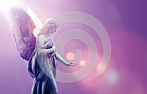 Angel in heaven over purple sky background photo