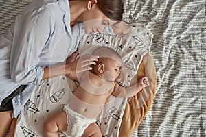 Angel like baby sleeping near mother after breastfeeding